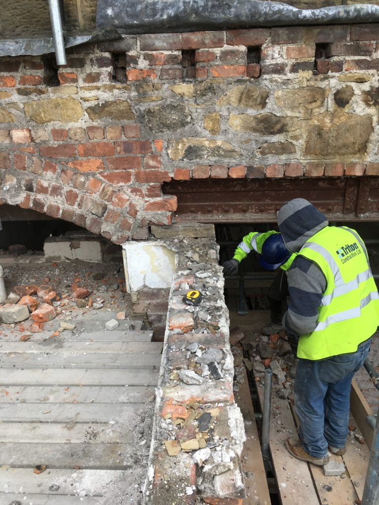 brick wall being knocked down
